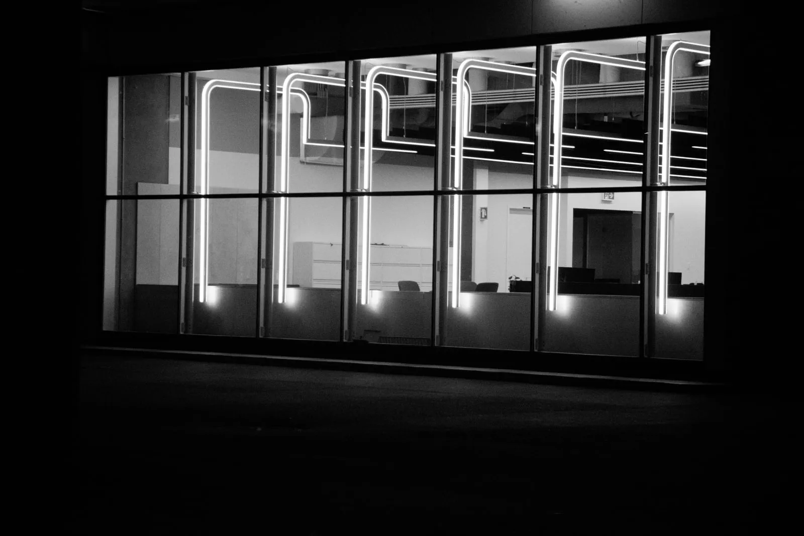 An empty office at night seen through a window