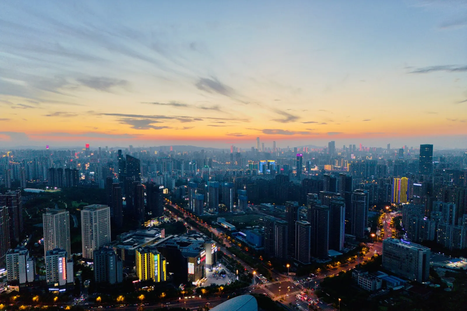 An aerial view of a city skyline at dusk