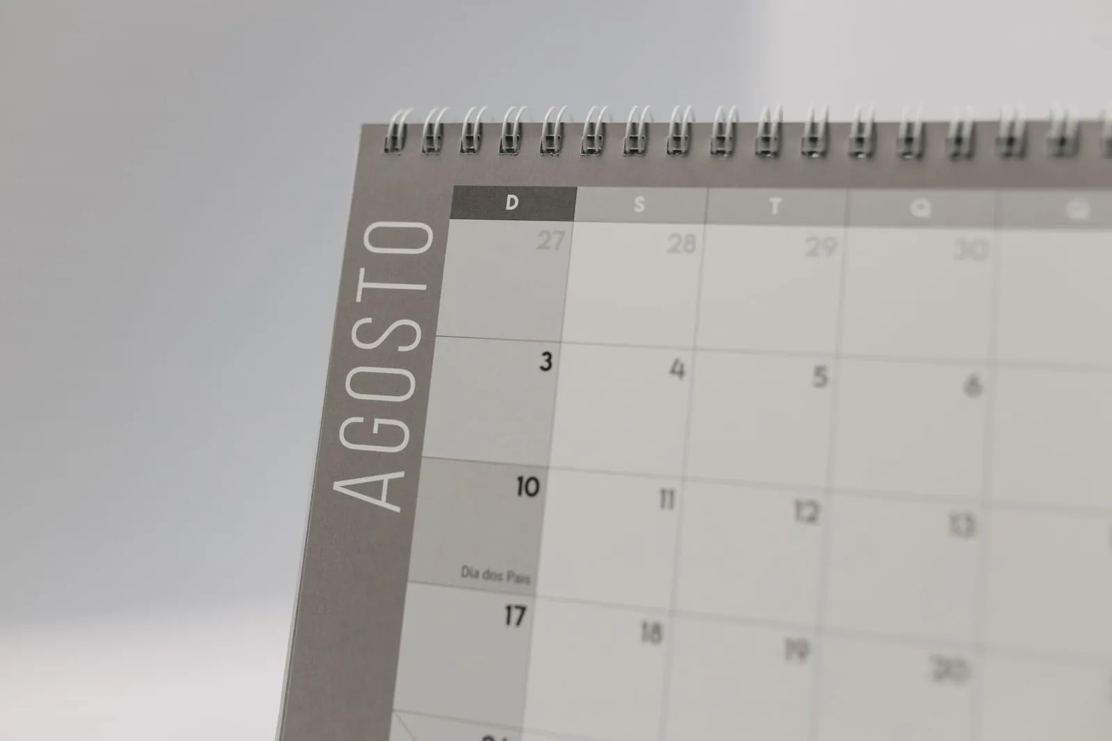 A desk calendar standing open at a month's page
