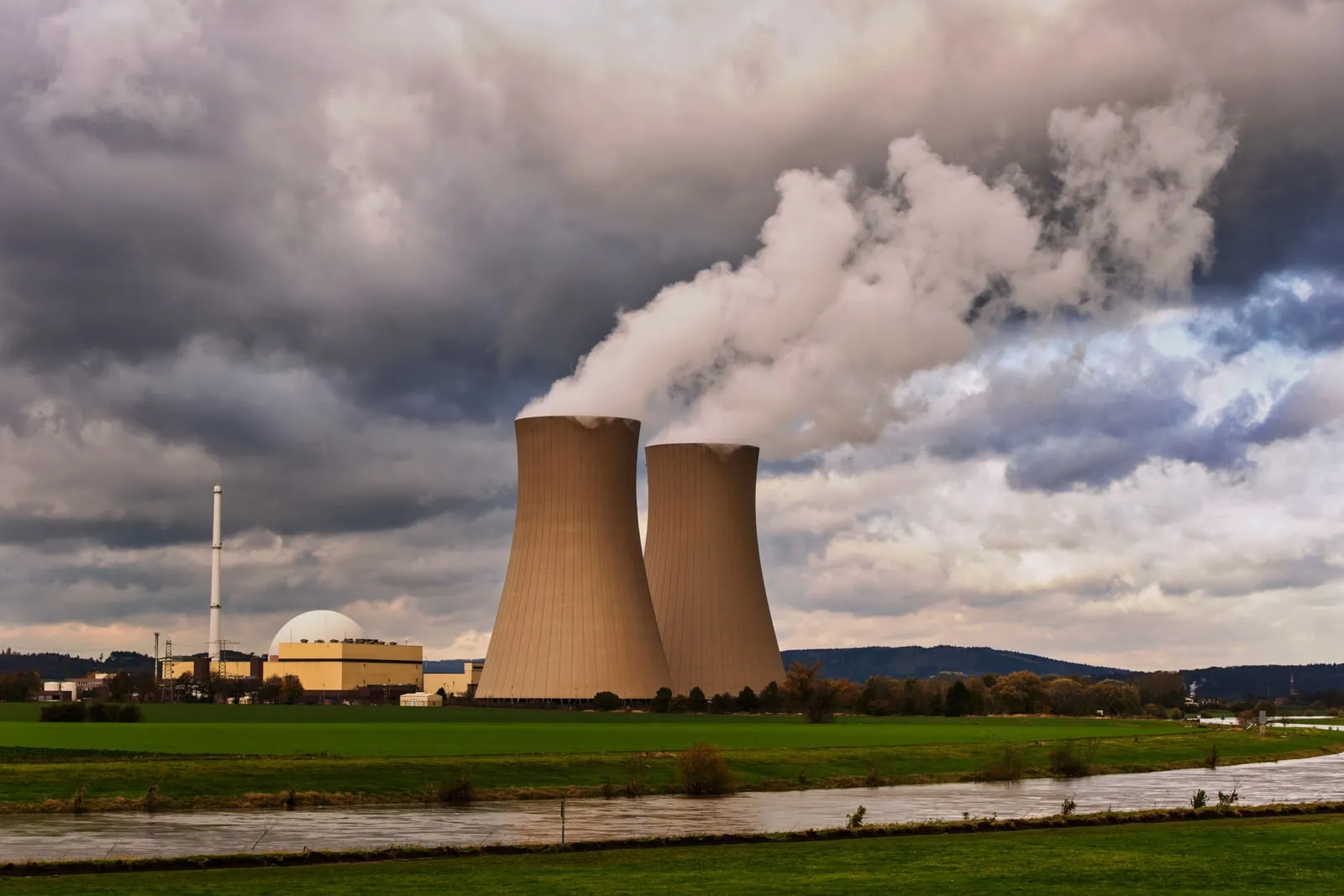 Cooling towers at a power station against an overcast sky