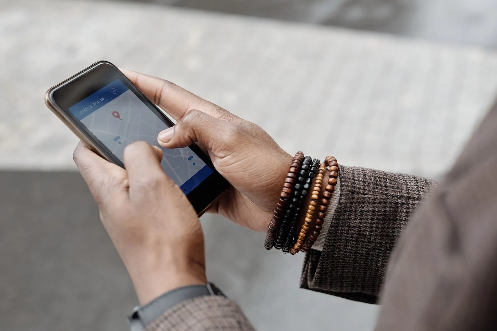 A hand holding a smartphone that is showing a map