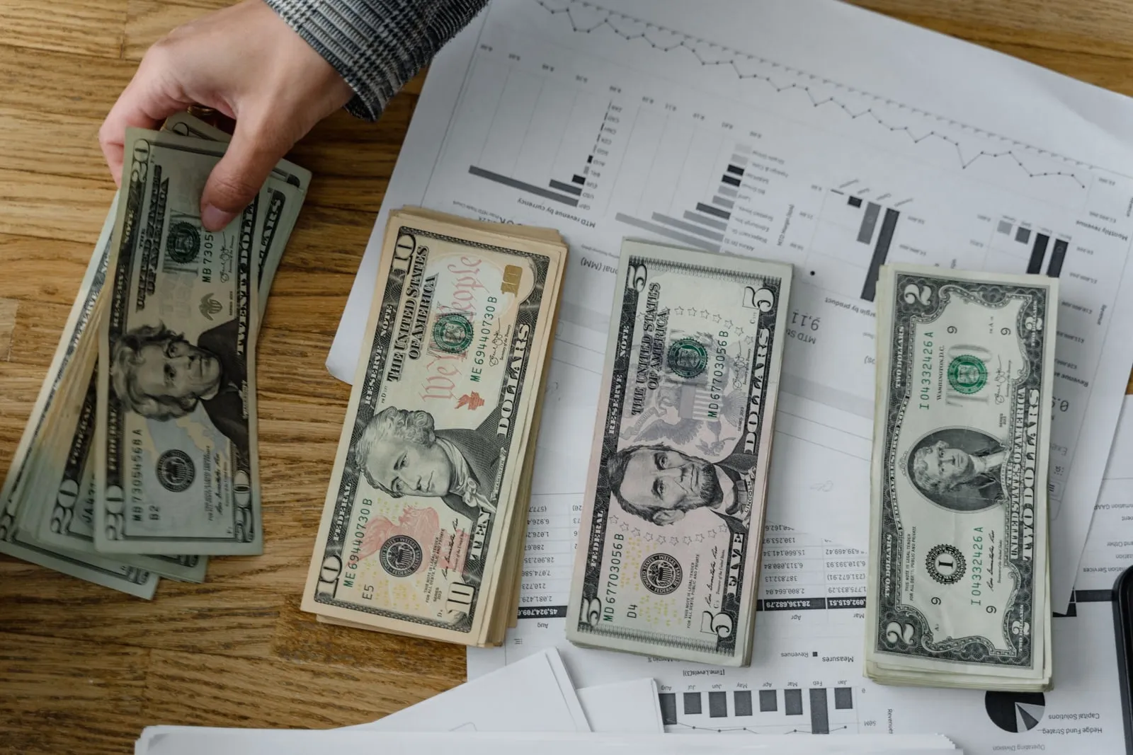 A stack of US dollar banknotes on a table