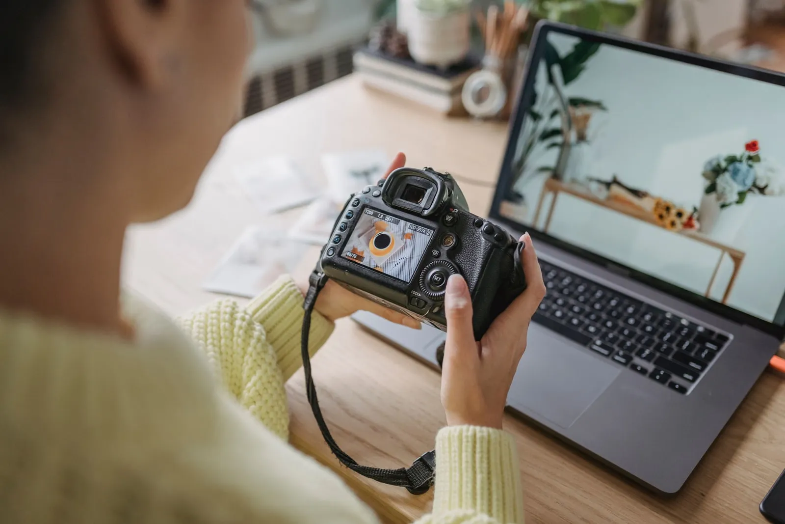 A photographer reviewing images on a laptop screen.