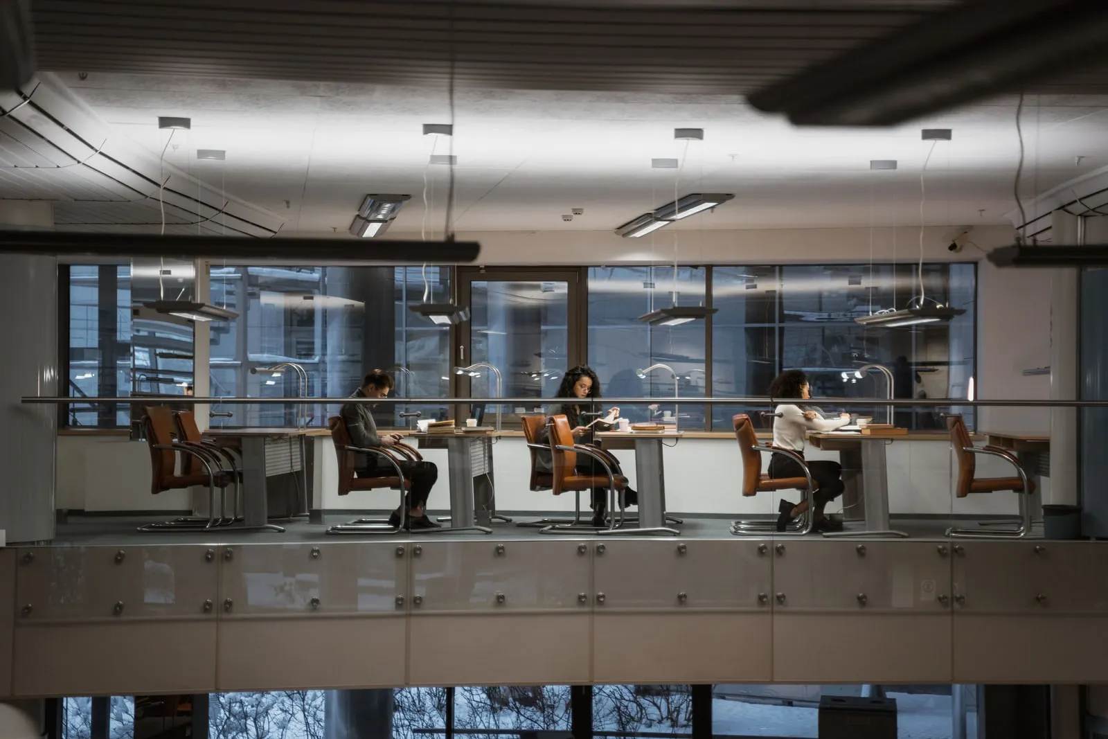 People reading at desks in a quiet library
