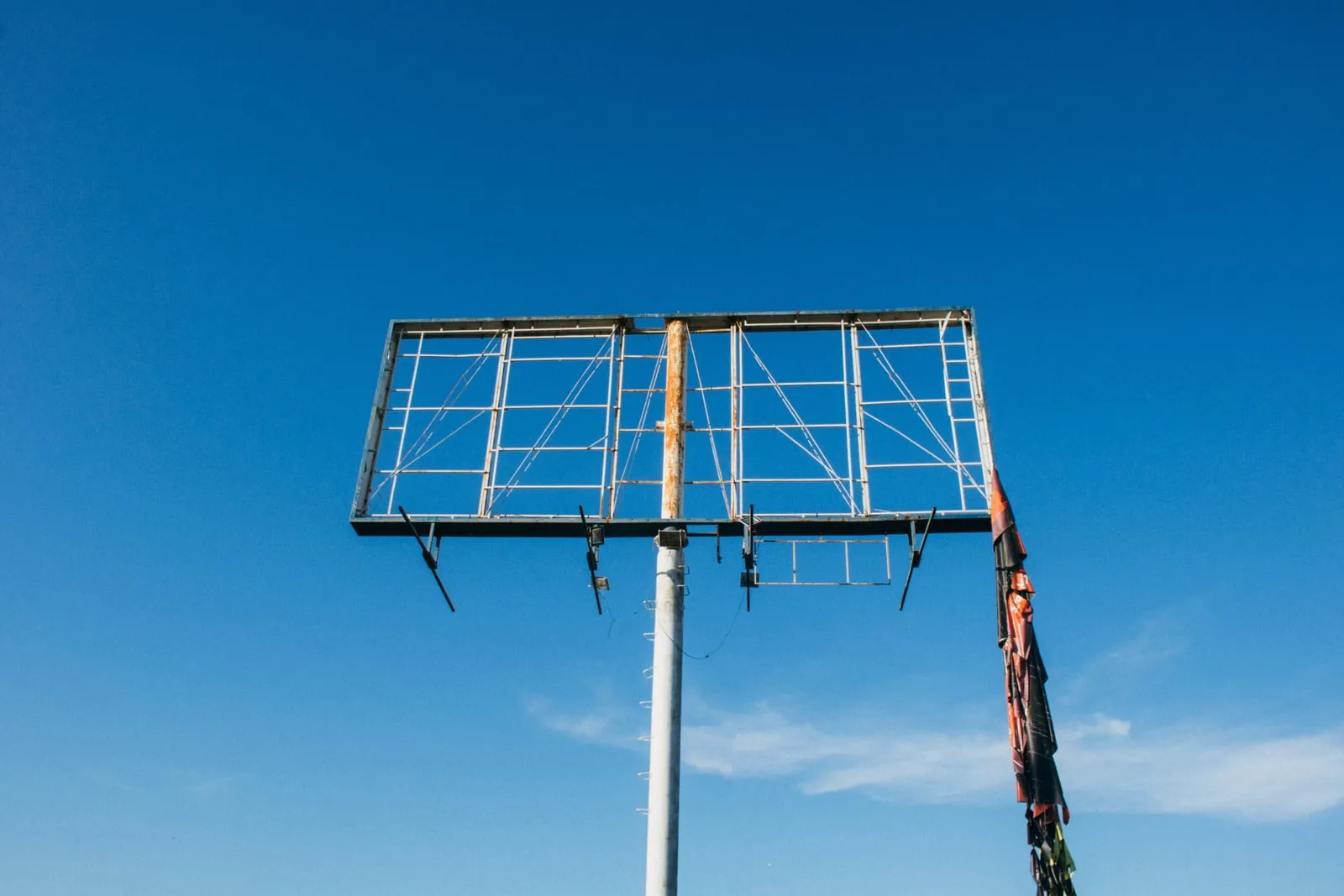 An empty billboard frame against the sky
