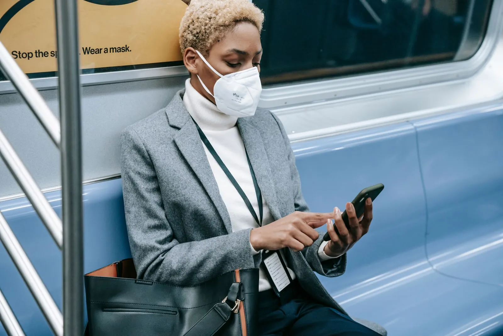 Person checking a smartphone on a commuter train