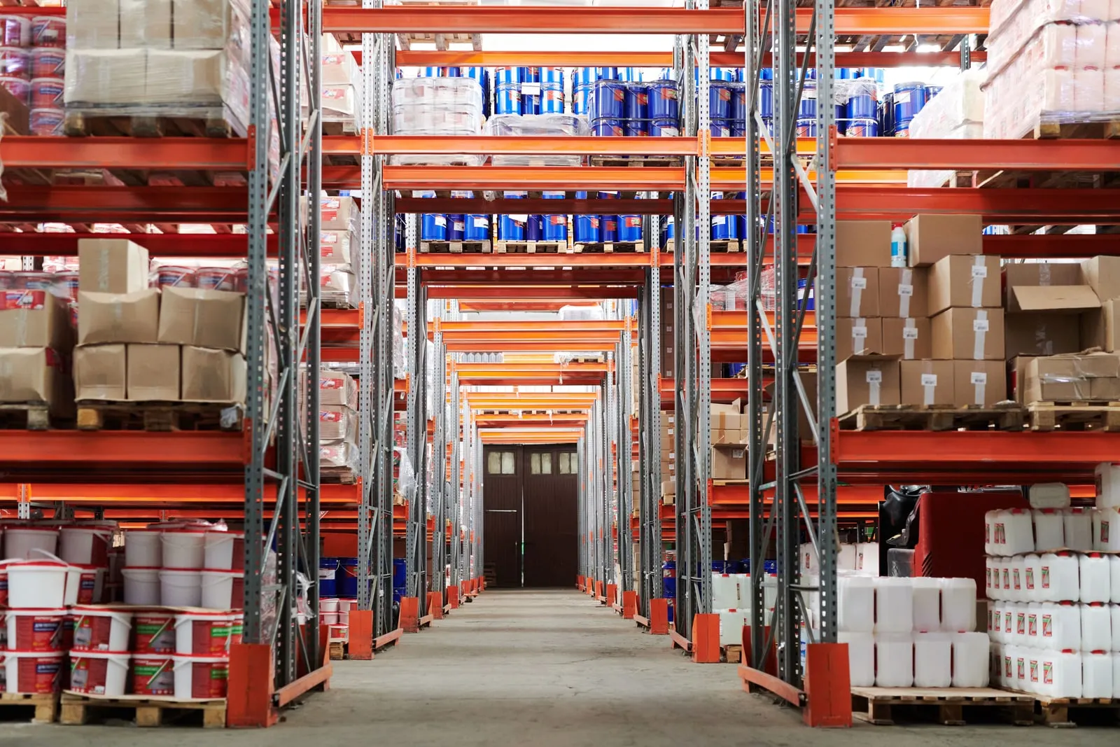 A warehouse aisle lined with pallets and shelving