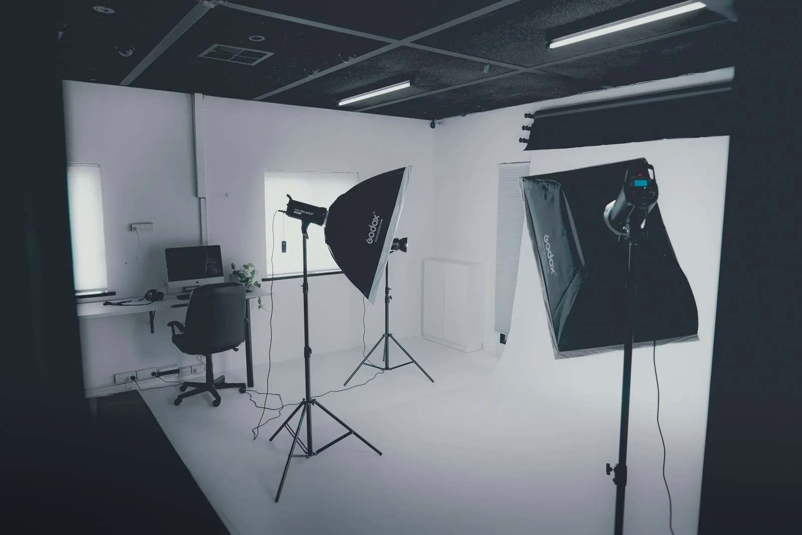 An empty photography studio with lighting stands