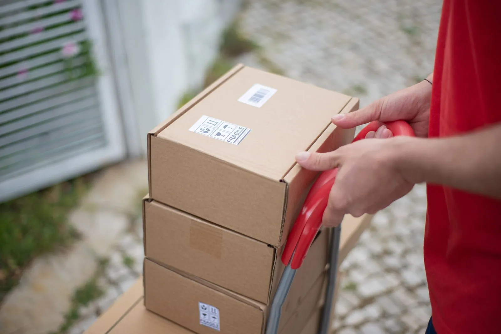 Cardboard parcels stacked on a delivery trolley