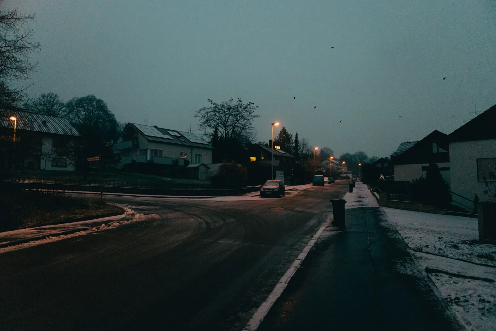 An empty residential street at dusk