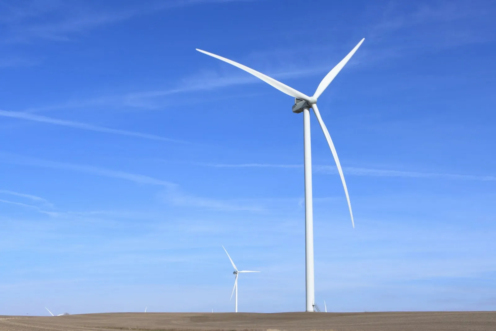 A wind turbine against a blue sky