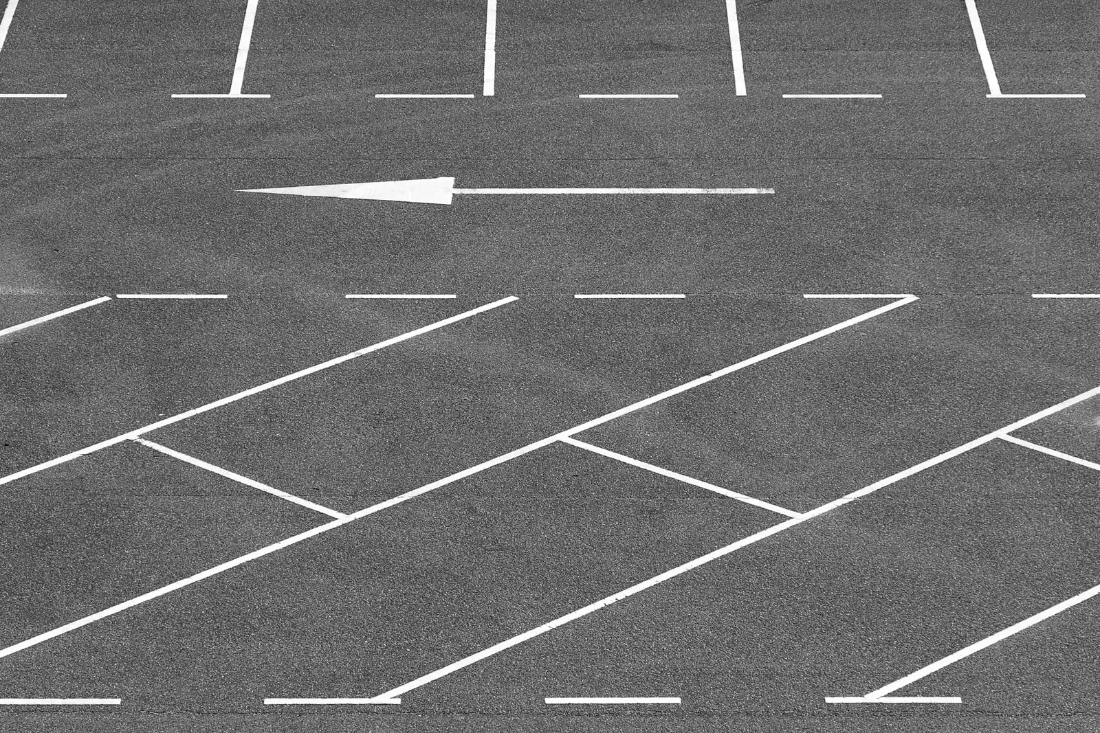An empty parking lot with painted markings seen from above