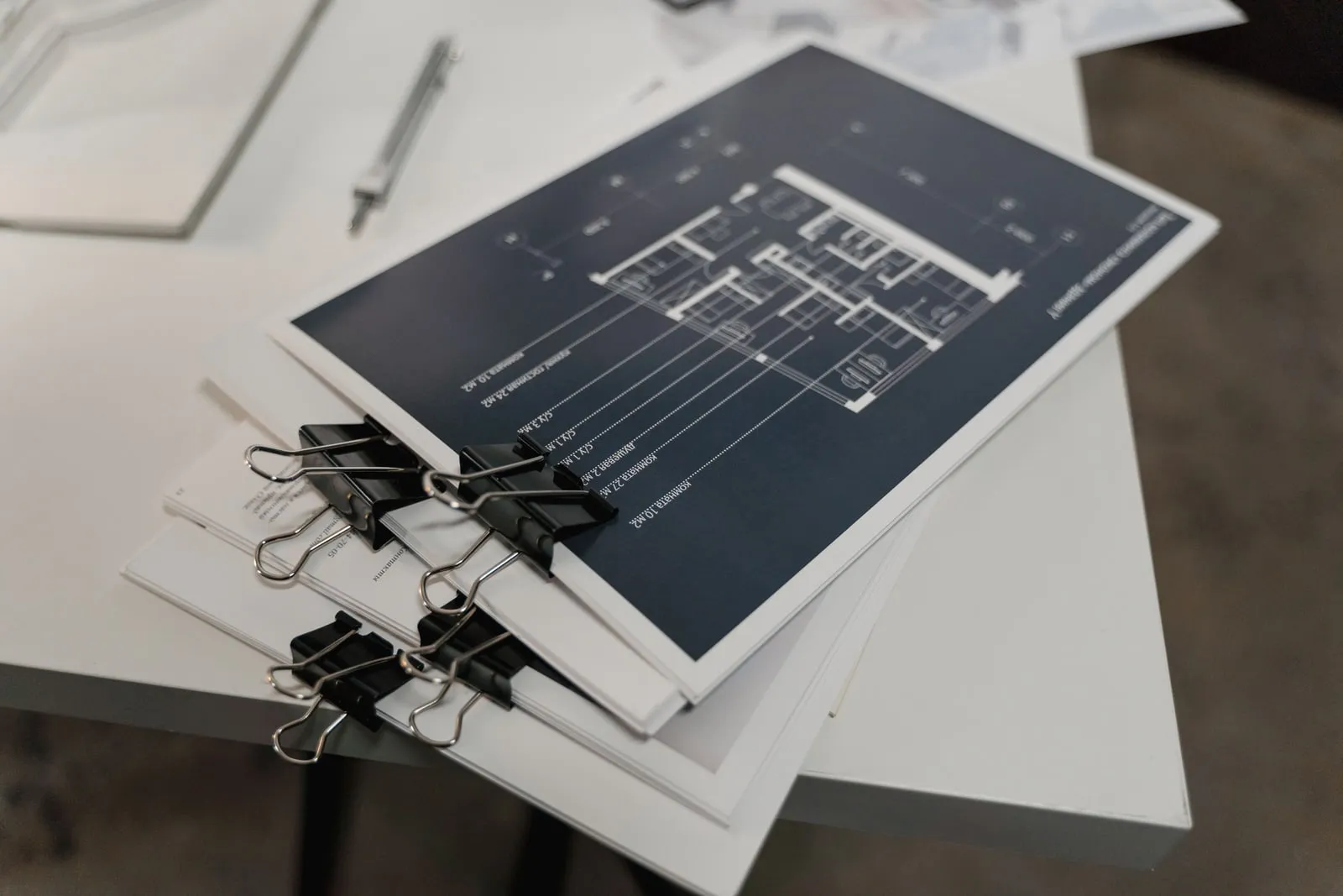 A stack of printed technical documents on a table